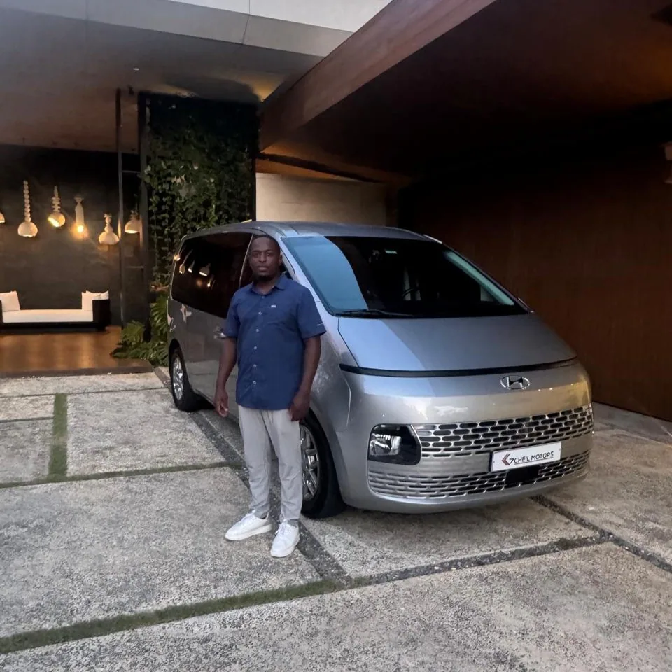Chauffeur waiting beside a black VIP van